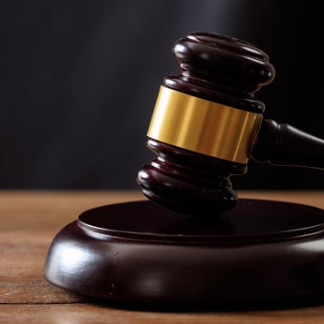 Judge Or Auction Gavel On A Wooden Desk P4UNMCN