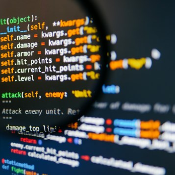 Program Code On Computer Display In Magnifying Gla 2022 04 28 02 46 28 Utc